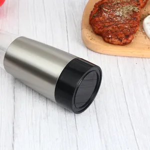 Stainless steel electric pepper grinder detail view, modern kitchen tool for salt and spices.