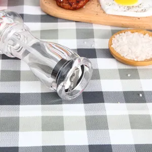 Manual acrylic pepper grinder detail view, clear spice mill for kitchen cooking and dining table use.