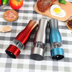 Stainless steel electric pepper grinder set with ceramic core for kitchen spice and salt grinding.