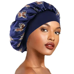 Close-up view of a blue satin hair bonnet with butterfly print and wide elastic band.