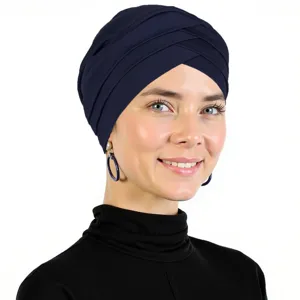 Close-up detail of the solid dark blue cross turban cap, showing soft milk silk fabric texture.