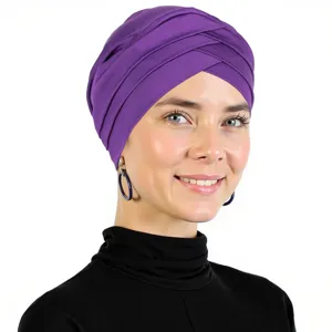 Close-up detail of the purple cross turban cap showcasing soft milk silk fabric and pleats.