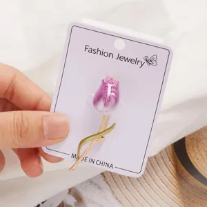 Close up view of the elegant purple tulip brooch featuring delicate painted enamel petals.