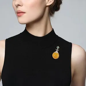 Exquisite detail view of traditional Chinese style yellow jade pipa brooch, elegant clothing pin.