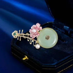 Chinese style pipa brooch detail, jade ring pearl pink flower accent, elegant jewelry ornament.