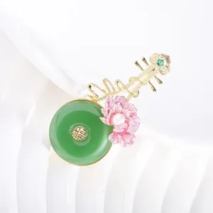 Exquisite Chinese style pipa brooch featuring green jade disc, pink flower, and pearl detail.