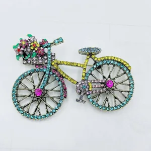 Nahaufnahme Detail der bunten Strass Fahrrad Brosche mit niedlichem Blumenkorb im Vintage Stil.
