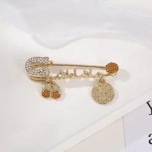 Exquisite gold safety pin brooch detail, vintage rhinestone religious style jewelry piece.