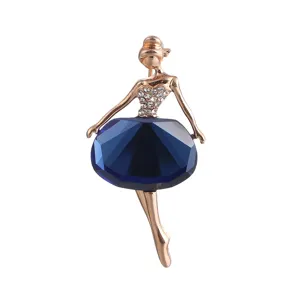 Detailed view of exquisite rose gold ballet dancer brooch with deep blue crystal skirt.