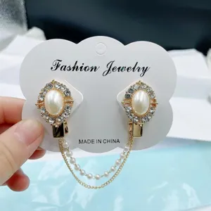 Vue rapprochée de clips de col en strass et perles, élégante broche gilet chaîne foulard.