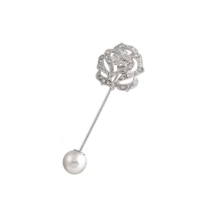 Detailed close-up shot of a silver rhinestone rose brooch with a faux pearl end pin.