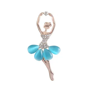 Close-up detail of the elegant rhinestone and blue cat-eye stone ballerina brooch pin.