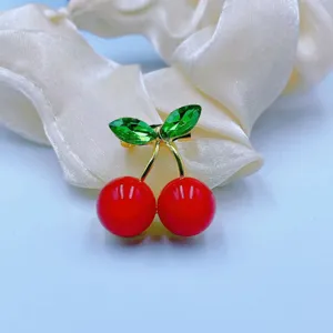 Cute cherry brooch pin with sparkling green crystal leaves and bright red fruit for women fashion.