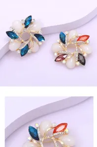 Elegant crystal flower brooch with colorful rhinestones, stylish gold-tone metal accessory for women's apparel.