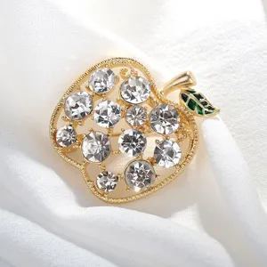 Crystal apple brooch detail shot, gold tone metallic finish with sparkling clear rhinestones.