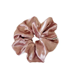 Pink satin floral hair scrunchie for women, elegant ponytail holder and cute hair accessory.