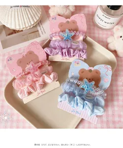 Detailed shot of cute Korean style mesh lace hair scrunchies set with sparkling star charms.