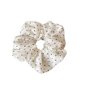 Creamy white polka dot hair scrunchie, soft fluffy fabric hair tie for cute everyday style.