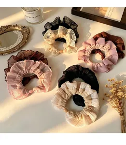 Detailed view of chic lace ruffle scrunchies with bead accents, stylish hair accessories for women.