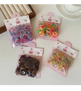 Colorful small rubber hair bands for kids, disposable elastic hair ties in bags, detail view.