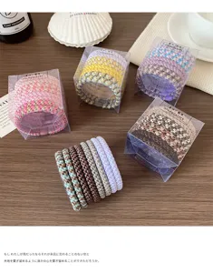 Colorful braided hair ties for women, stylish elastic hair ropes and ponytail holders set in clear boxes.