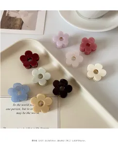 Detail view of small acrylic flower hair claw clip, perfect for elegant daily half-up hairstyles.