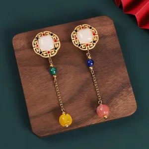 Close-up detail of Chinese retro style metal brooch featuring white stone and colorful beads.