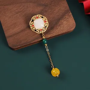 Retro Chinese style brooch detail with gold frame, white jade and elegant hanging bead chain.