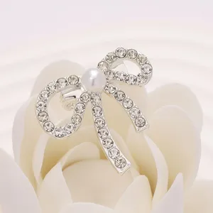 Élégante broche nœud perle strass pour femmes, accessoire bijou épingle de revers argenté.