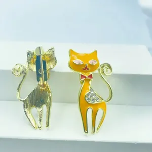 Close-up detail of the cute enamel cat brooch showing front rhinestones and back pin.