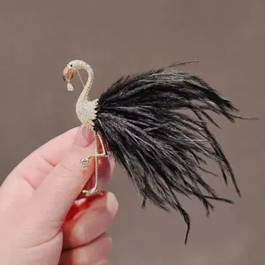 Exquisite flamingo brooch featuring black feather tail and sparkling crystal accents for women.