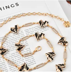 Gold metal chain belt with black heart charms and rhinestones for women dress styling accessory.