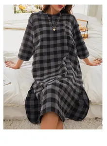 Detailed view of women's cozy grey plaid nightgown, casual flannel sleepwear for autumn.