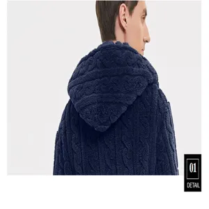 Detailed view of dark blue plush fleece hooded bathrobe showing jacquard fabric texture.