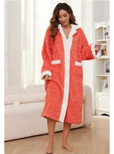 Cozy coral fleece bathrobe detail, soft plush fabric texture, warm winter sleepwear lifestyle.