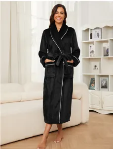 Detailed view of women black plush flannel bathrobe with elegant white trim and matching belt.