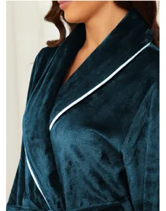 Close-up detail of soft deep blue flannel bathrobe with white trim, cozy fabric texture view.
