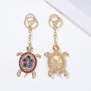 Alloy evil eye turtle keychain bag pendant with rhinestones, cute sparkling accessory.