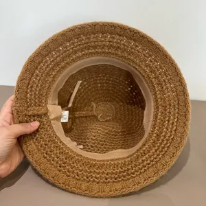 Brown knitted bucket hat interior detail showing fine woven texture and soft inner sweatband.