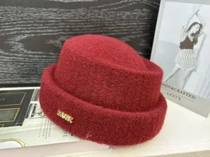 Red wool fisherman hat winter warm woolen cap with metallic music letter decoration style.