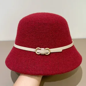 Red felt bucket hat with chic beige belt and metal buckle, stylish autumn accessory.