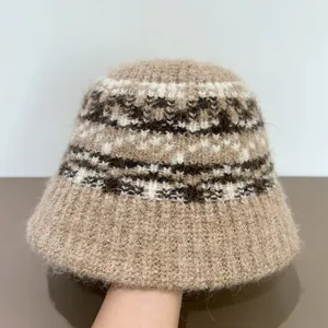 Knitted bucket hat detail showcasing the cozy fuzzy texture and ethnic winter geometric pattern.