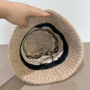 Detailed view of the autumn winter knitted bucket hat with cozy furry fabric and chic inner pattern.