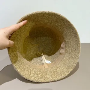 Detail view of a stylish tweed bucket hat interior lining, autumn winter fashion hat.
