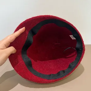 Red wool bucket hat interior detail showing wide brim and quality lining craftsmanship.