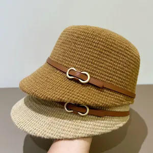Womens knit bucket hat detail showcasing the soft texture, brown leather belt and chic metal buckle.