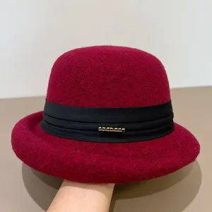 Elegant red wool felt bowler hat with black ribbon and metallic detail for women chic style.