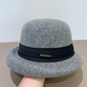 Grey wool felt dome hat detail view, elegant winter cloche hat with black ribbon decoration.