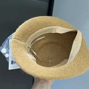 Stylish autumn winter bucket hat with inner ribbon detail and pearl accessory for women.