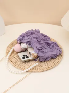 Detailed view of purple rose floral clutch bag with pearl metal chain strap for women evening party.